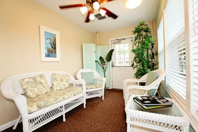 Bright common area with wicker seating and plants