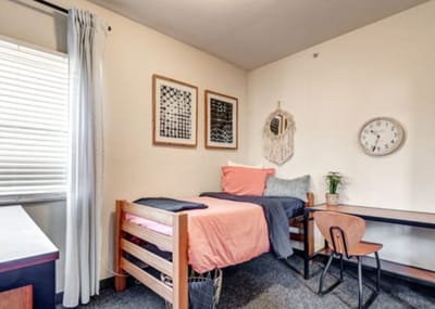 Cozy private resident room with bed and desk