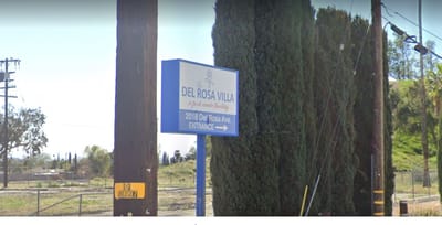 Signage indicating the entrance of Del Rosa Villa