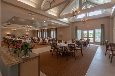 Dining area with tables and chairs set for meals
