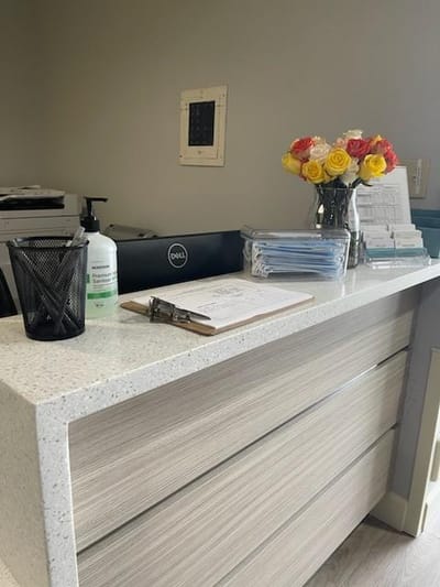 Reception desk with flowers and paperwork
