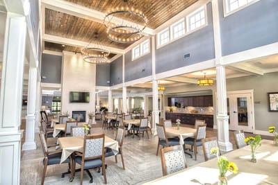 Bright dining room with tables set for residents