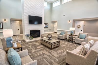 Bright common area with seating and fireplace