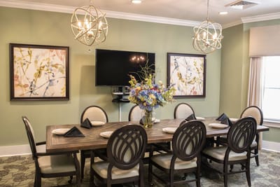 Dining room with a large table and floral centerpiece