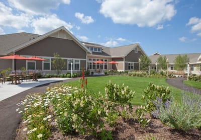 Exterior view of a senior living facility with garden area