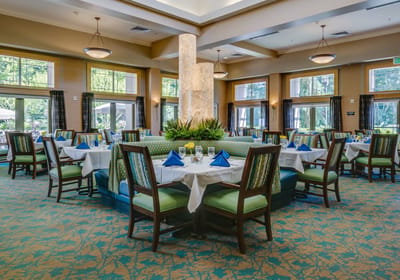 Elegant dining room setup with tables and green decor