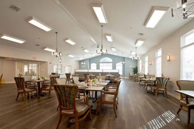 Bright dining room with tables and chairs set up for meals