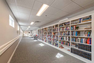 Bright hallway with bookshelves and seating area