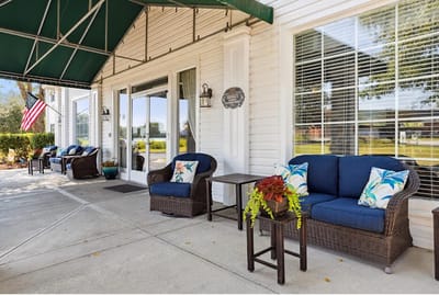 Outdoor seating area with plants and flag