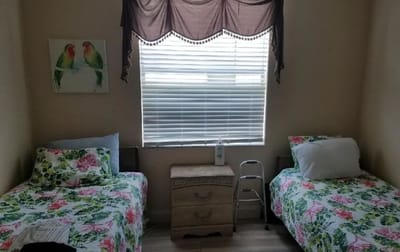 Private resident room with two beds and decorative bedding