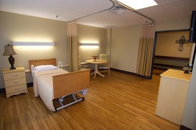 A private resident room with furniture and wooden flooring