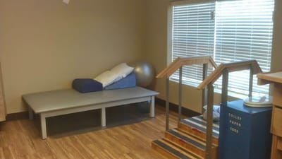 Rehabilitation room with equipment and a therapy area