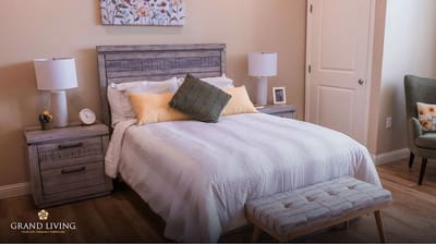 Well-decorated private resident room with bed and nightstand