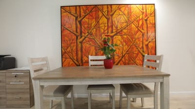 Cozy dining area with a wooden table and art on the wall