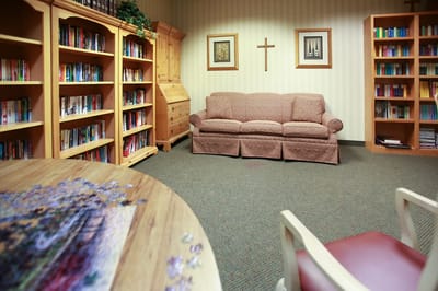 Cozy common area with bookshelves and a couch