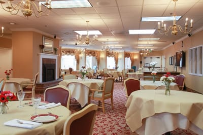 Elegantly set dining room with flower centerpieces