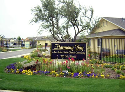 Exterior view of the Harmony Bay facility sign with landscaping