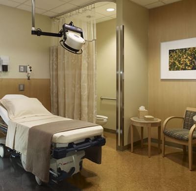 Clean, well-lit patient room with medical equipment