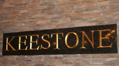 Facility logo displayed on stone backdrop