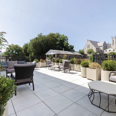 Outdoor patio area with seating and greenery