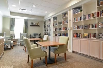 A cozy common area with bookshelves and seating