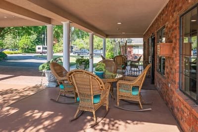 Outdoor seating area with wicker chairs and tables