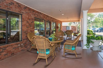 Outdoor seating area with rocking chairs and tables