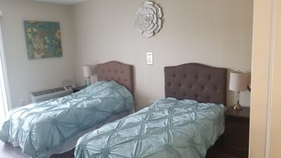 Cozy twin bedroom setup with decorative wall art