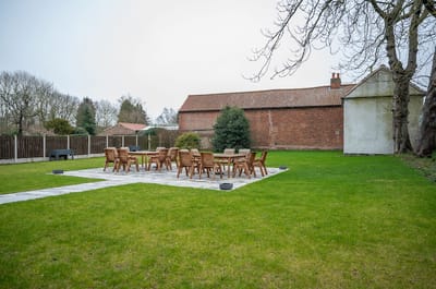 Outdoor space with tables and chairs in a grassy area