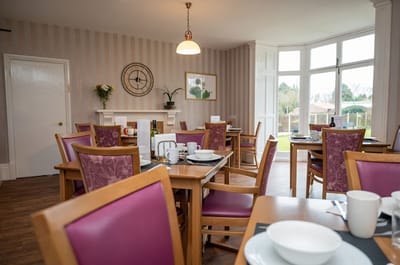 Dining room set up for a meal with outdoor view