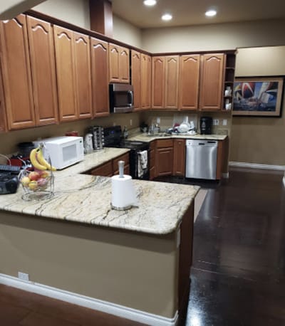 Bright kitchen with wooden cabinets and granite countertops