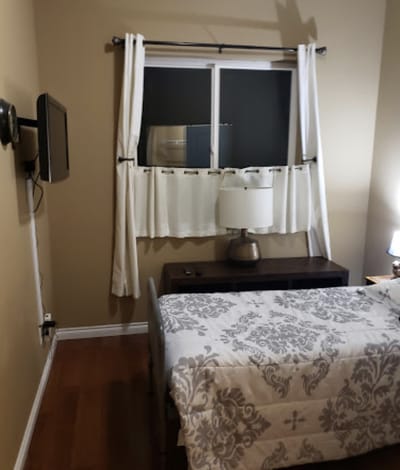 Cozy resident room with a bed and lamp