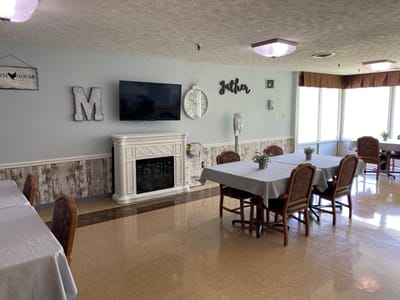 Bright dining area with tables and a fireplace