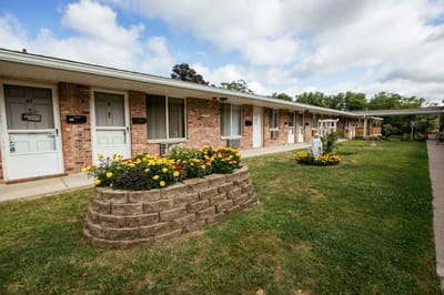 Outdoor space with flower beds in front of resident rooms