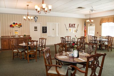 Dining area with tables and chairs set for meals