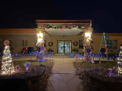 Festively decorated entrance with lights and candy canes