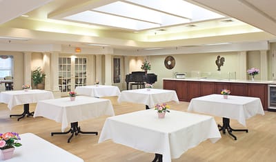 Bright dining room with tables and floral arrangements