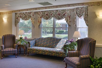 Cozy common area with floral furniture and natural light