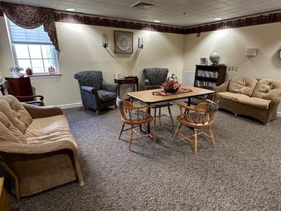 Warm common area with seating and bookshelves