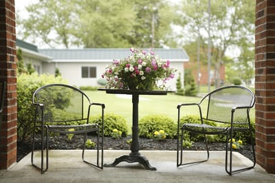 Outdoor patio area with seating and flowers