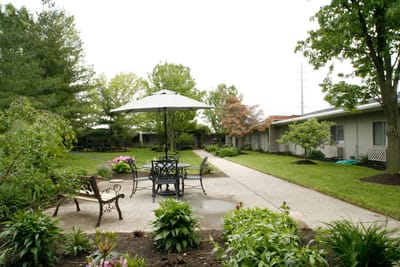 Outdoor patio area with seating and greenery