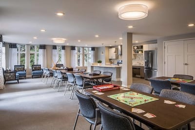 Bright common area with tables for games and activities