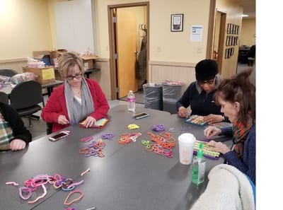 Residents engaged in a crafting activity at a table