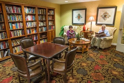 Residents reading in a cozy library area