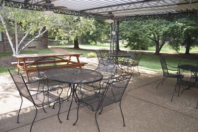 Outdoor seating area with tables and chairs