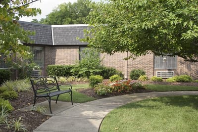 Pathway and seating in the garden area of the facility
