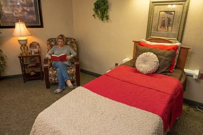 Resident reading in a cozy private room