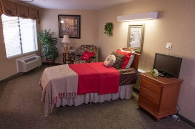 Cozy resident room with a bed and chair