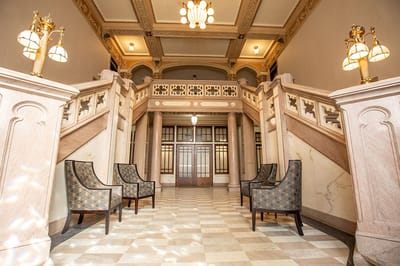 Interior lobby with elegant staircase and chairs