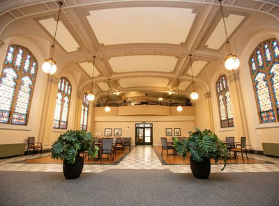 Interior view of a common area with stained glass windows